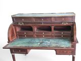 a wooden desk with a marble top and drawers