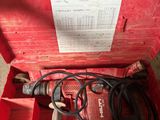 a red box with a drill and a cord in it