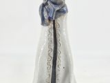 a figurine of a woman in a white robe and scarf