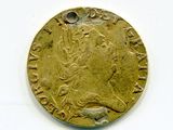 an old gold coin with a picture of a woman on it