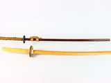 pair of japanese wooden swords on a white background