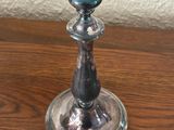 a silver candle holder sitting on a wooden table
