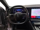the interior of a car with a steering wheel, dashboard, and display screen