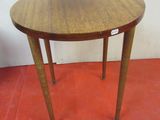 a small table with a wooden top on a red floor