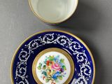 a close up of a cup and saucer on a table