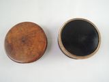 two wooden boxes with black lids on a white surface