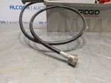 a close up of a hose on a table with a sign in the background