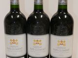 three bottles of wine are lined up on a white surface