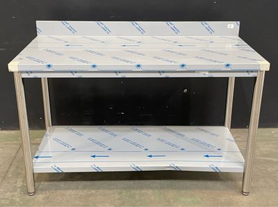 an image of a stainless steel work table with a plastic shelf