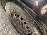 a black car that has a flat tire on the street