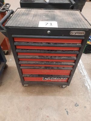 two red drawers are stacked on top of each other in a garage