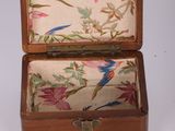 a small wooden box with a floral design on it