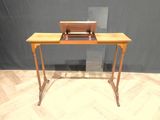 a small desk with a laptop on top of it