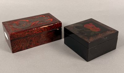 two small wooden boxes with designs on them sitting on a table
