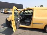 a yellow van with its door open in a parking lot