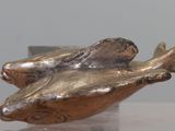 a statue of a frog that is sitting on top of a table