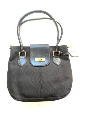 black and blue handbag on white background with gold hardware