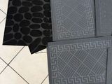 four mats on the floor next to a pair of shoes