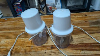 two salt and pepper shakers sitting on a wooden table