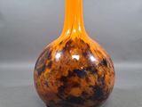 a vase that is sitting on a table with a gray background