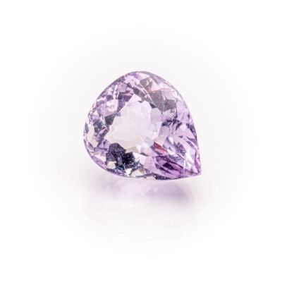 a close up of a purple diamond on a white surface