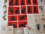 a lot of postcards on the table with pictures of cats