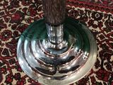 a vase with a flower in it sitting on a table