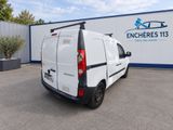 the back end of a white van parked in a parking lot