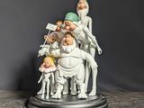 a figurine of a group of people sitting on a table