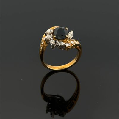 a gold ring with a black stone and white diamonds
