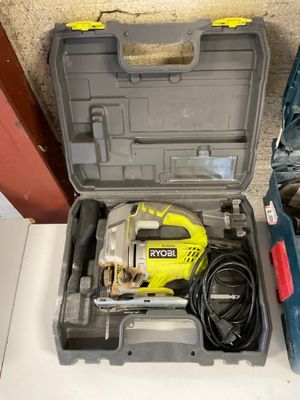a tool box with a drill and a corded cord in it