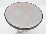 a small metal table with a glass top on a white surface
