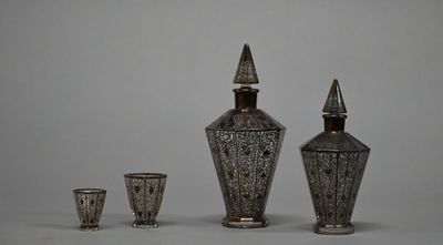 three silver vases sitting next to each other on a table