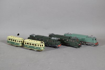three toy trains sitting next to each other on a gray surface