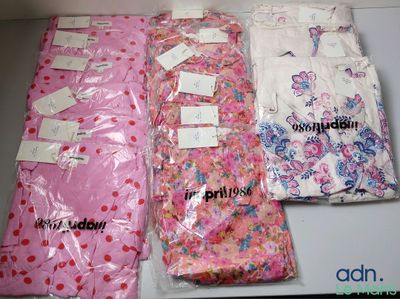 four bags of clothing that are sitting on a table