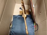 a blue purse and a gold cane in a cardboard box