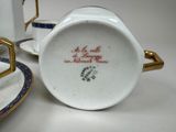 a cup and saucer sitting on a table next to a plate