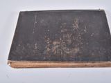 an old book that is sitting on a table