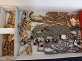 a box full of gold and silver jewelry on a table