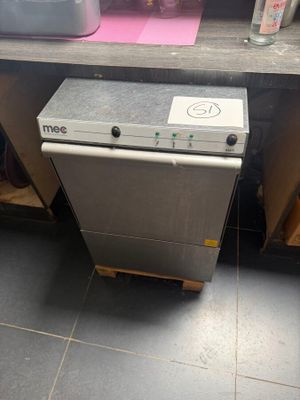 a silver dishwasher sitting on a counter in a kitchen