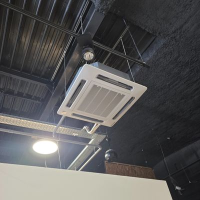 ceiling mounted air conditioner mounted to the ceiling of a building