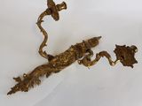 an antique brass figurine of a bird and flowers on a branch