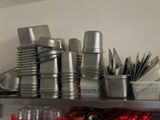 many cups and pans on the shelf in the kitchen