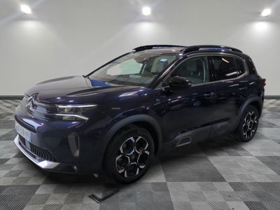 a blue 2020 toyota c - hr suv parked on a checkered floor