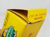 a yellow box with a green pen inside of it