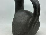 a black vase that is sitting on a white surface