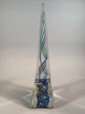 a blue and green glass sculpture on a clear base
