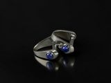 a close up of a pair of silver rings with blue stones