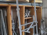 a pile of metal pipes and a wooden shelf in a room