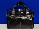 a black purse with a silver handle on a white table